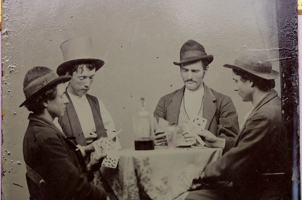 Photo allegedly showingBilly The Kid, Richard M. "Dick" Brewer, Frederick Tecumseh Waite and Henry Newton Brown playing cards, though there is no evidence to back this allegation. Public Domain.